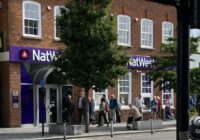 A queue of customers wait for Natwest to open this summer.